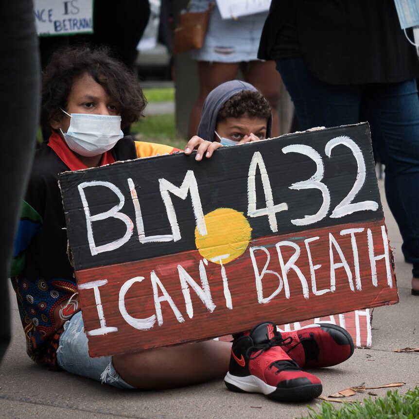 Aboriginal children holding Black Lives Matter sign at protest