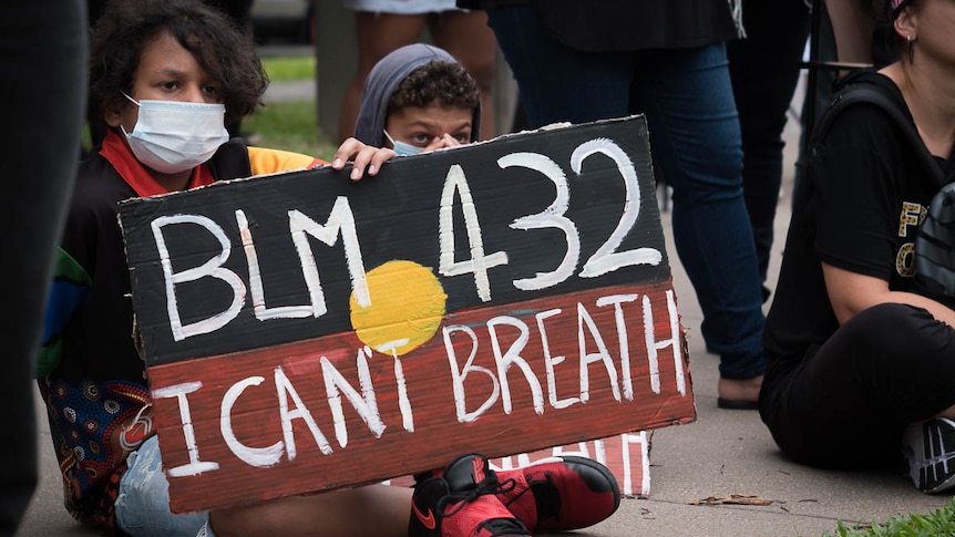 Aboriginal children holding Black Lives Matter sign at protest