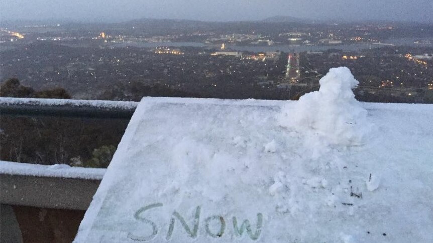 A mini snowman on Mount Ainslie overlooks a chilly Canberra.