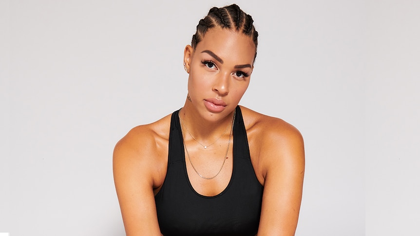 Liz Cambage infront of a while background