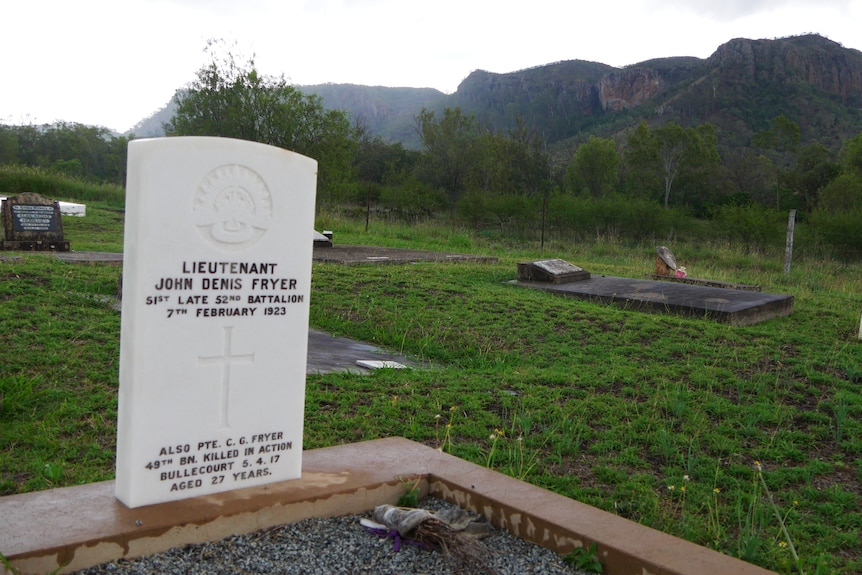 A gravesite with mountains in the background.