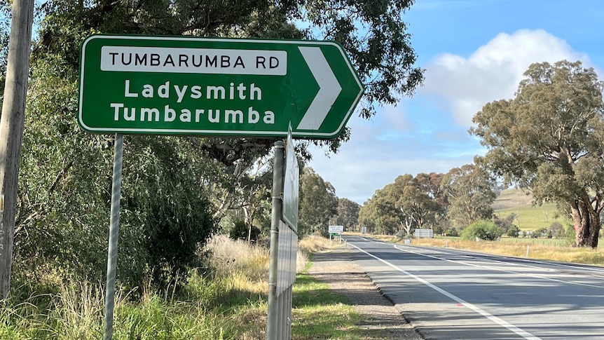 A green road sign that says 'Tumbarumba Road'