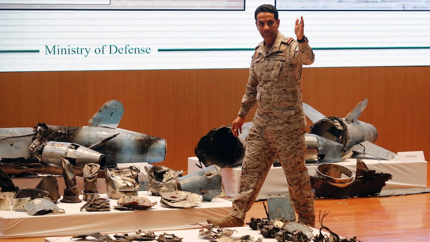 Saudi military spokesman Colonel Turki al-Malki stands in front of what he said were Iranian cruise missile and drones.