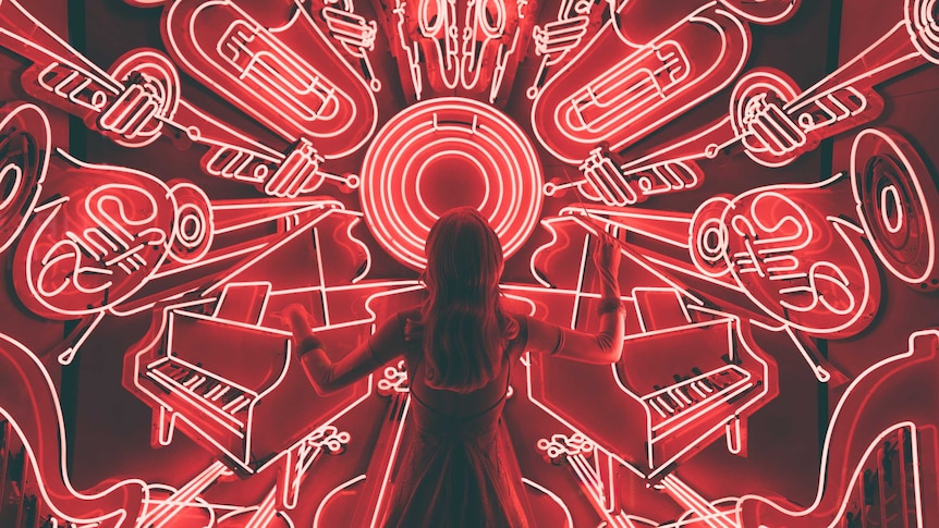 A woman is lit up by glowing red neon instruments