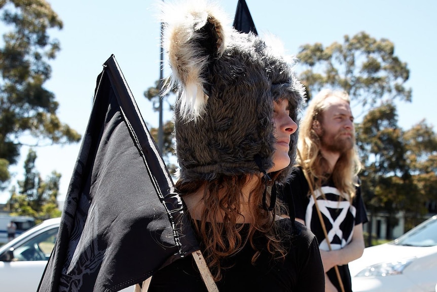 woman advocating for koala rights wears koala hat at rally
