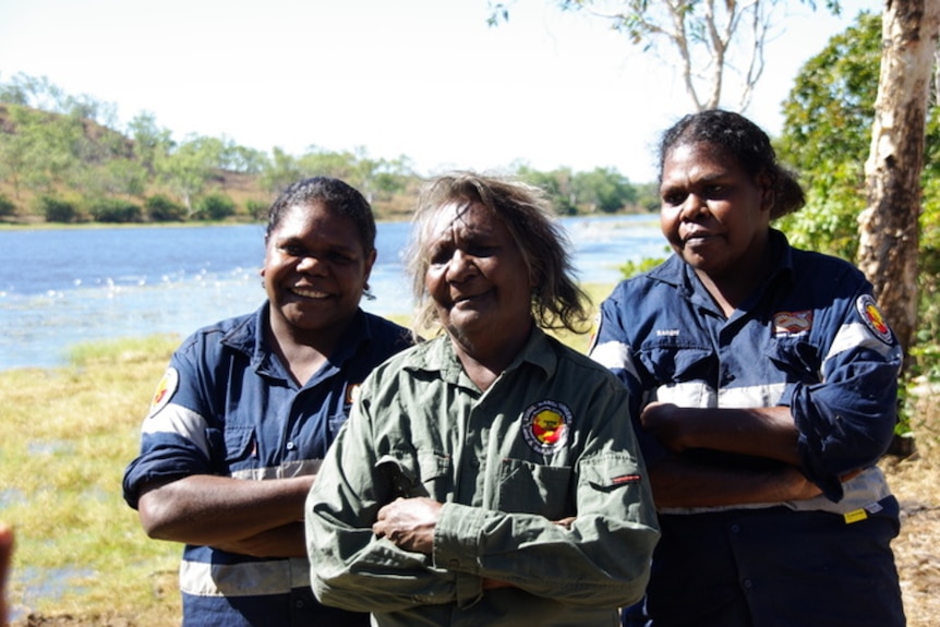 Three indigenous women rangers with arms folded
