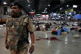 A policeman stands guard after shootings at a railway station in Mumbai