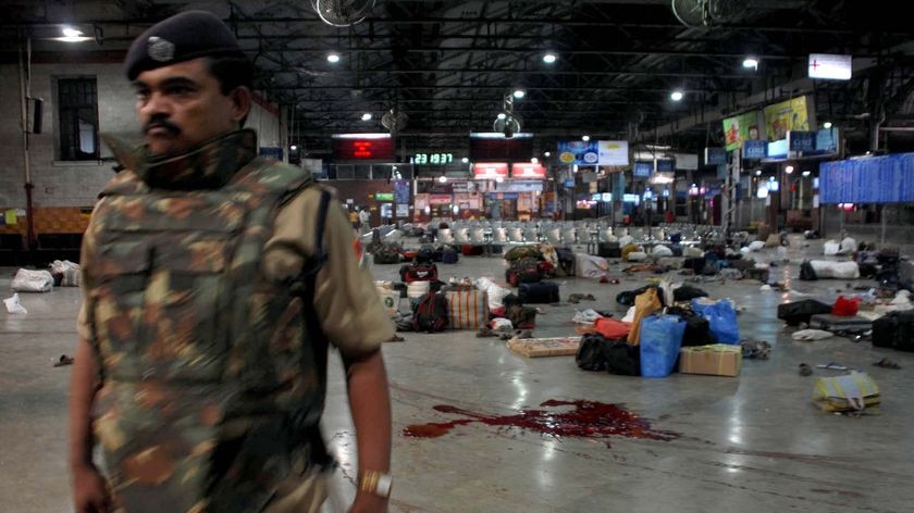 A policeman stands guard after shootings at a railway station in Mumbai