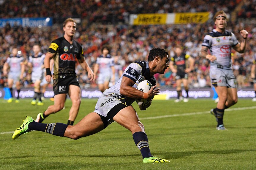 Justin O'Neill of the Cowboys scores a try against the Panthers at Penrith Stadium on April 9, 2016.