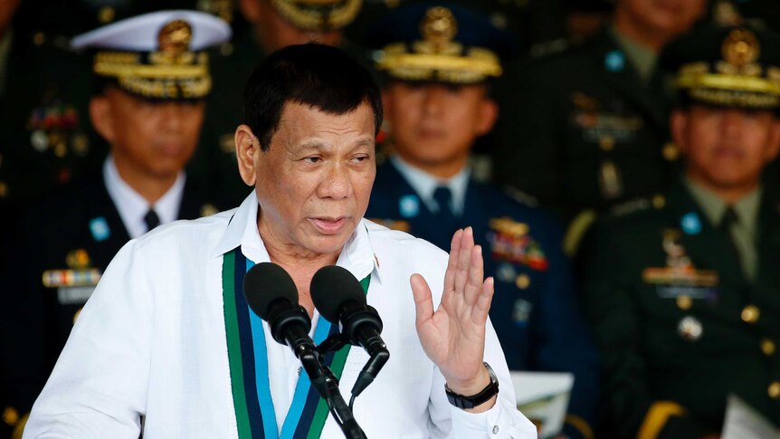 Rodrigo Duterte stands at a lectern speaking.