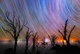 Star trails captured over a lake