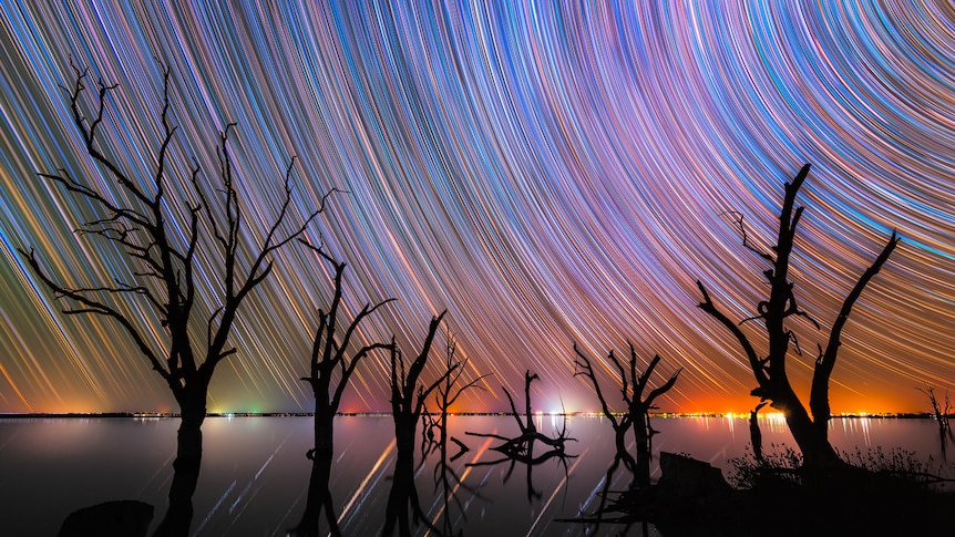 Star trails captured over a lake