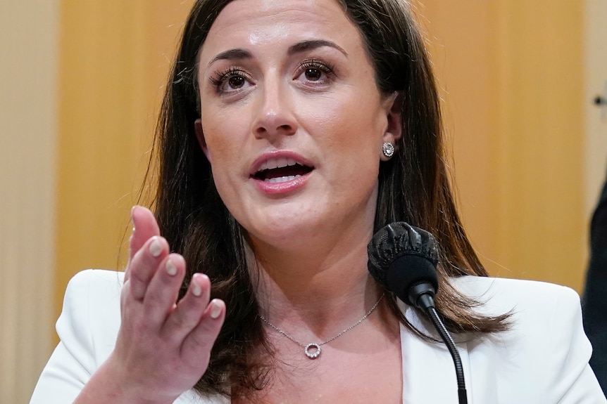 Close up of former White House aide Cassidy Hutchinson in a white jacket testifying at the Jan 6 committee