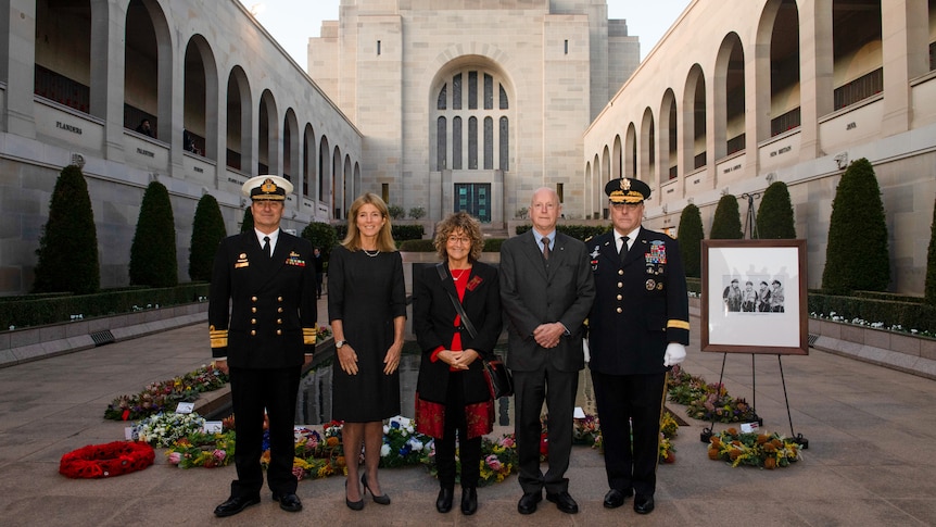 A number of people, including Caroline Kennedy, near the Pool of Reflection at the Australian War Memorial.