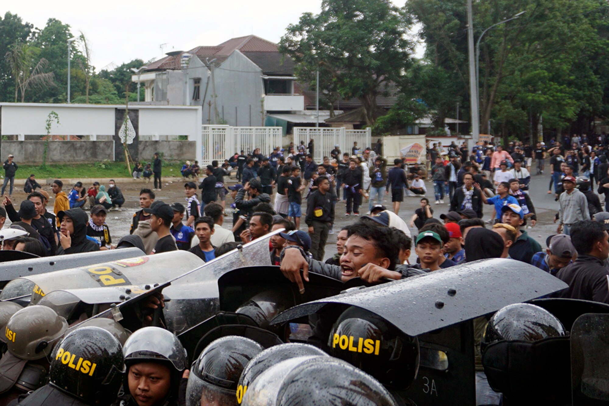 A group of football fans clash with riot police. 
