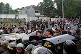 A group of soccer fans clash with riot police. 