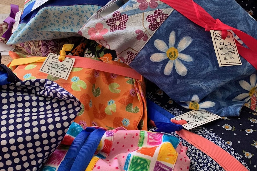 A collection of brightly coloured hand sewn reusable period kits.