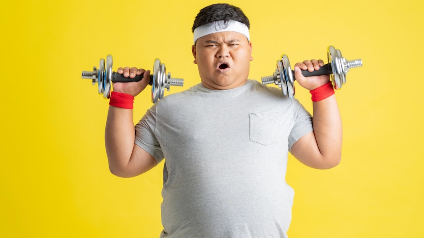 Asian man lifting weights against yellow background