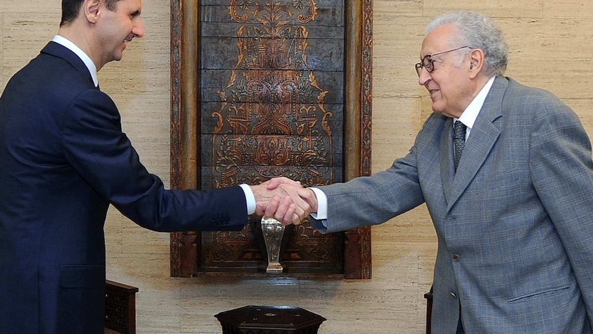 Bashar al-Assad shaking hands with International peace envoy Lakhdar Brahimi during their meeting in Damascus.