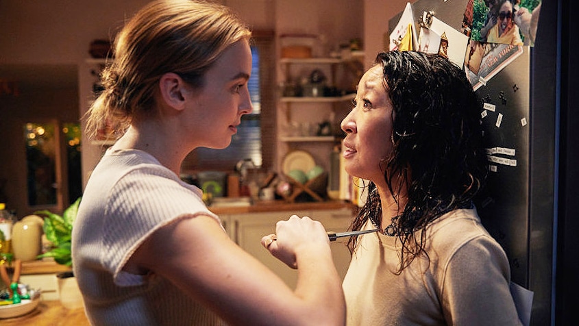 Screenshot from TV show Killing Eve where Jodie Comer's character, Villanelle, holds knife to Sanda Oh's character, Eve.