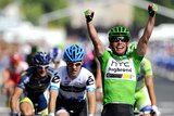 Mark Cavendish celebrates as he crosses the finish line on the Champs-Elysees