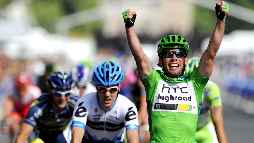 Mark Cavendish celebrates as he crosses the finish line on the Champs-Elysees