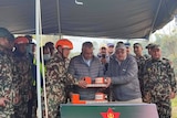 An image of officials holding the black box, following the Yeti Airlines plane crash in Nepal.