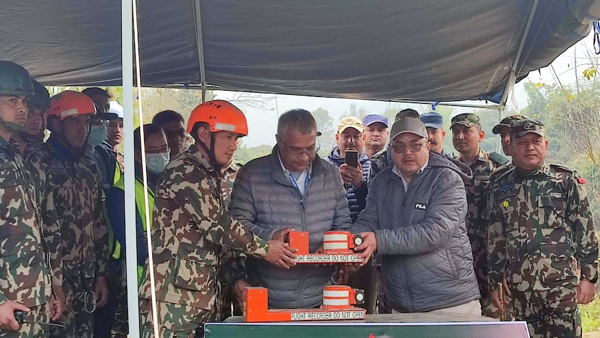 An image of officials holding the black box, following the Yeti Airlines plane crash in Nepal.