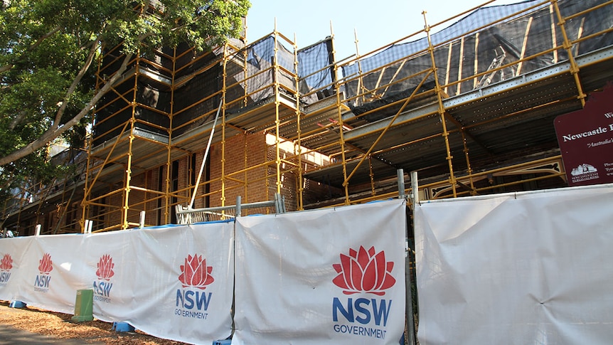 School fenced off, surrounded by scaffolding