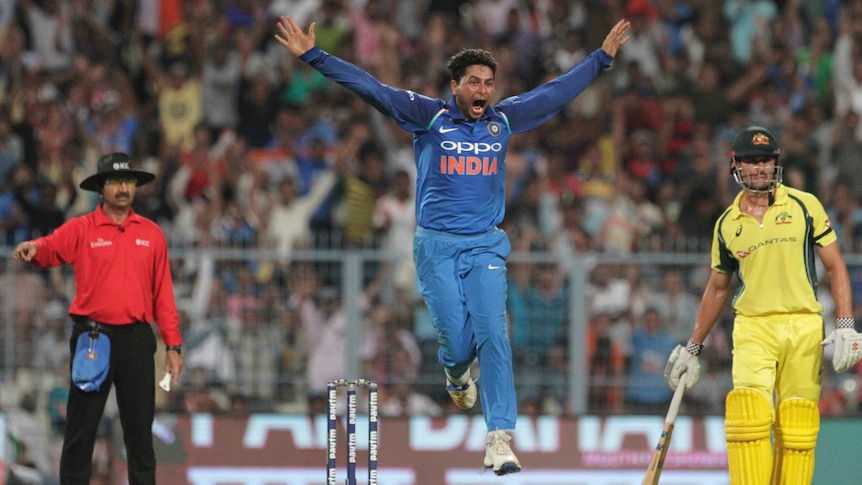 Kuldeep Yadav jumps in the air after taking an Australian wicket.