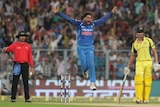 Kuldeep Yadav jumps in the air after taking an Australian wicket.