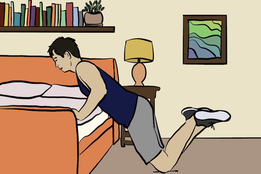 Person in singlet and shorts leans with bent arms against a bed with knees on the floor and feet raised behind them.