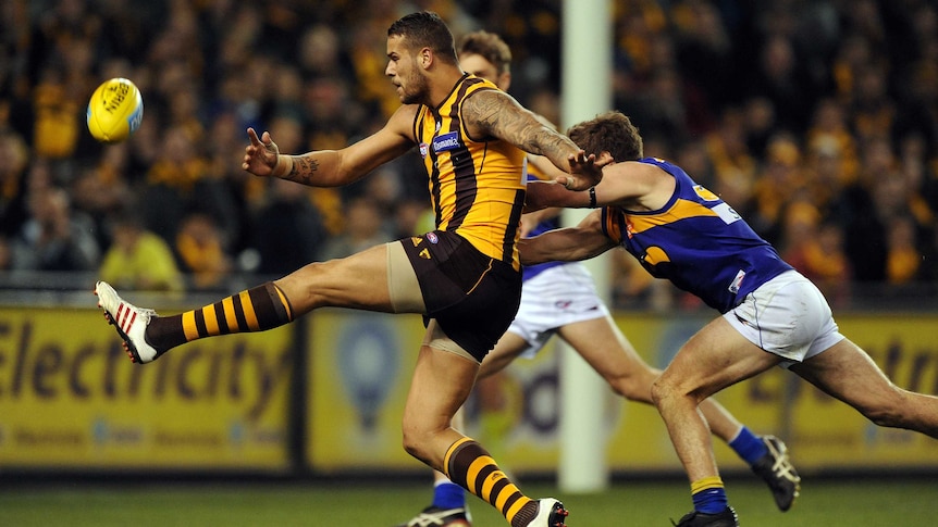 The Hawks' Lance Franklin takes a shot for goal against West Coast in round 13, 2013.