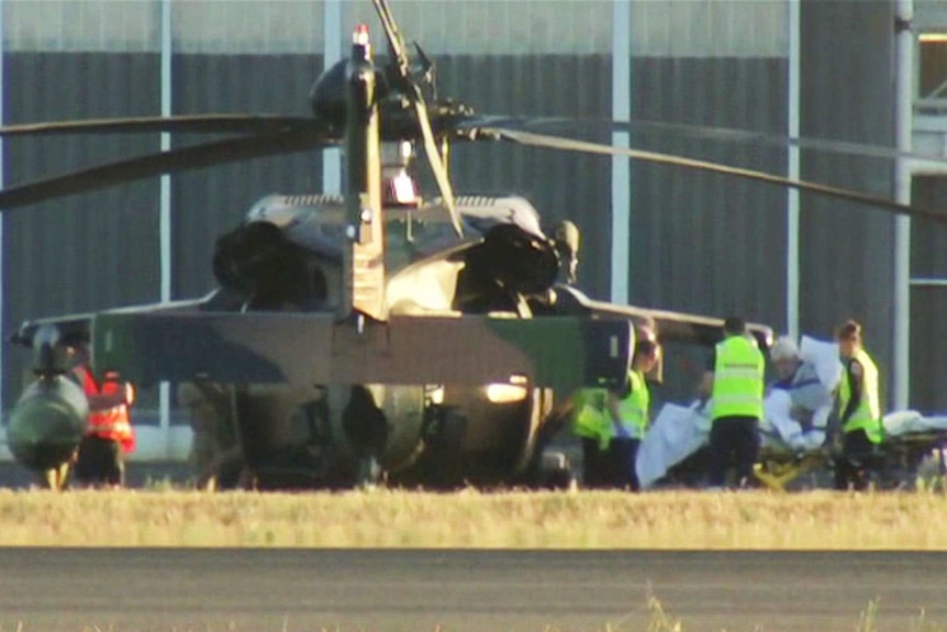 A Black Hawk helicopter on the ground at RAAF East Sale, unloading a sick patient.