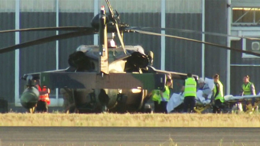 A Black Hawk helicopter on the ground at RAAF East Sale, unloading a sick patient.
