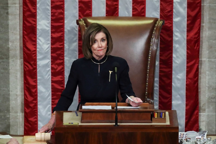 Nancy Pelosi holding a gavel at the US House of Representatives