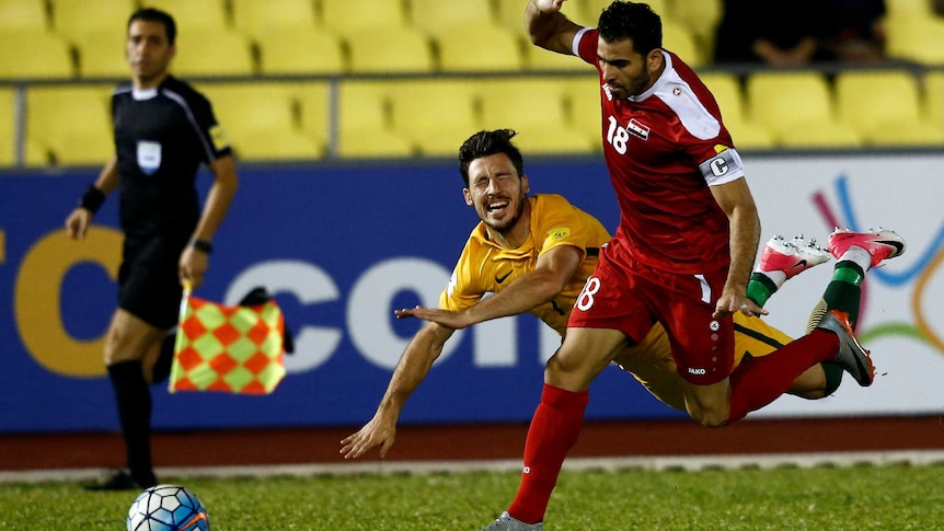 Socceroos player Matt Leckie flys through the air