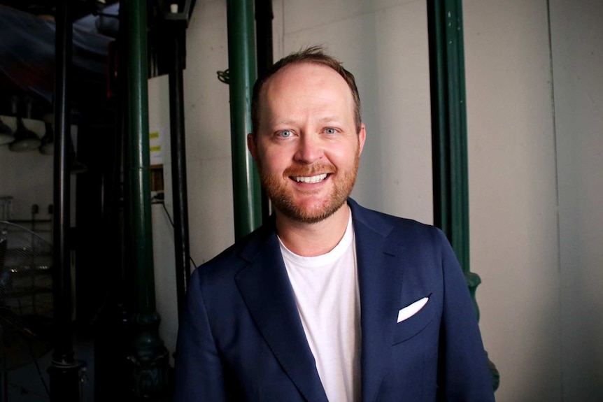 a man smiling backstage