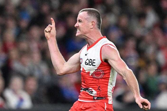 AFL player Chad Warner, yells in excitement after kicking a goal