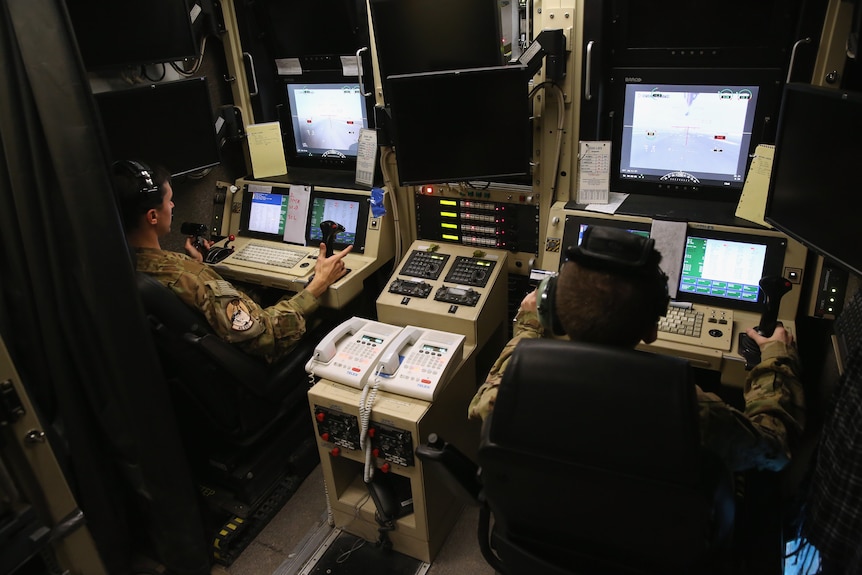 US Air Force pilot and a censor operator prepare for a drone attack.