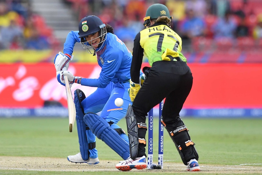 An Indian cricketer plays a cut shot past the Australian wicketkeeper in the Women's T20 World Cup in Sydney.