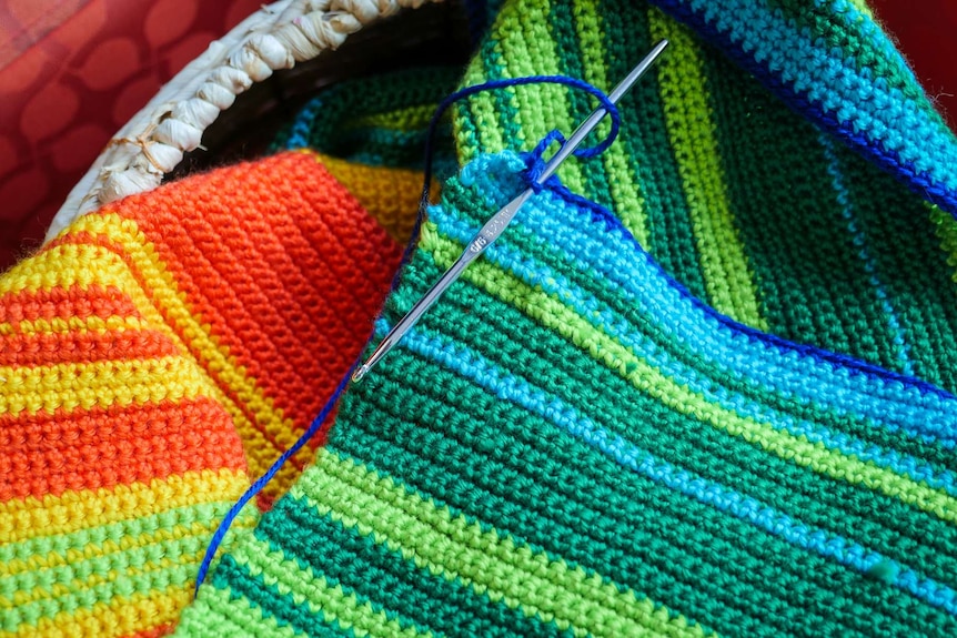 Crochet needle and blanket.