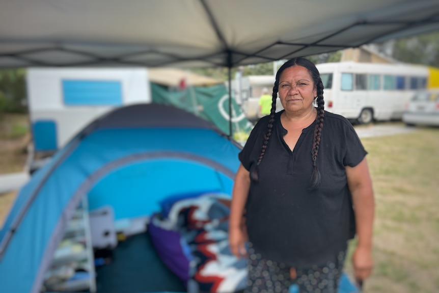 Woman standing in front of tent