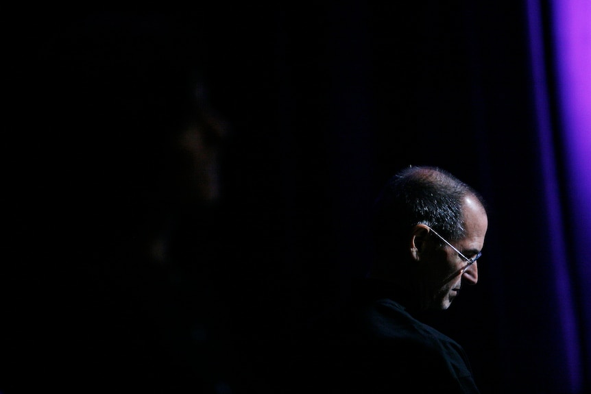 Steve Jobs listens to several of the company's application partners speak after announcing the new iPhone 3G