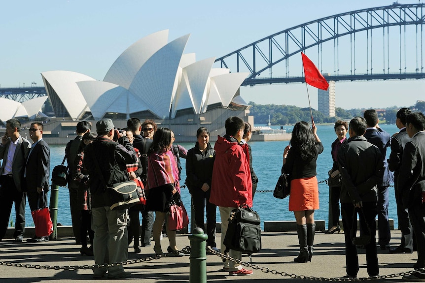 Tourists visit the Sydney Opera House