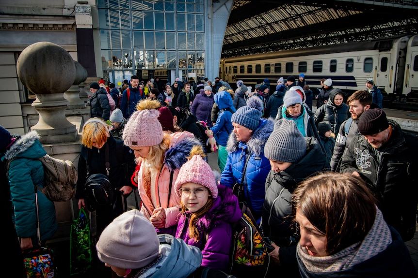 A small girl among the crowd looks to the camera. 