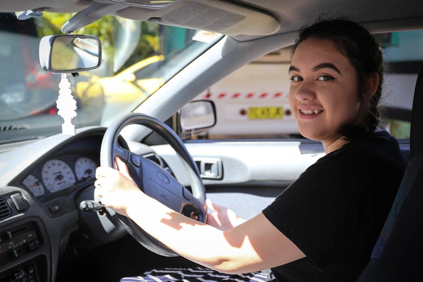 Saraya Halverson-Dunwoodie in the driver's seat of her car