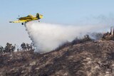 A plane assists in putting out a forest fire