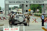 Pakistani security personnel block a road linked to the Kamra air base in Kamra.