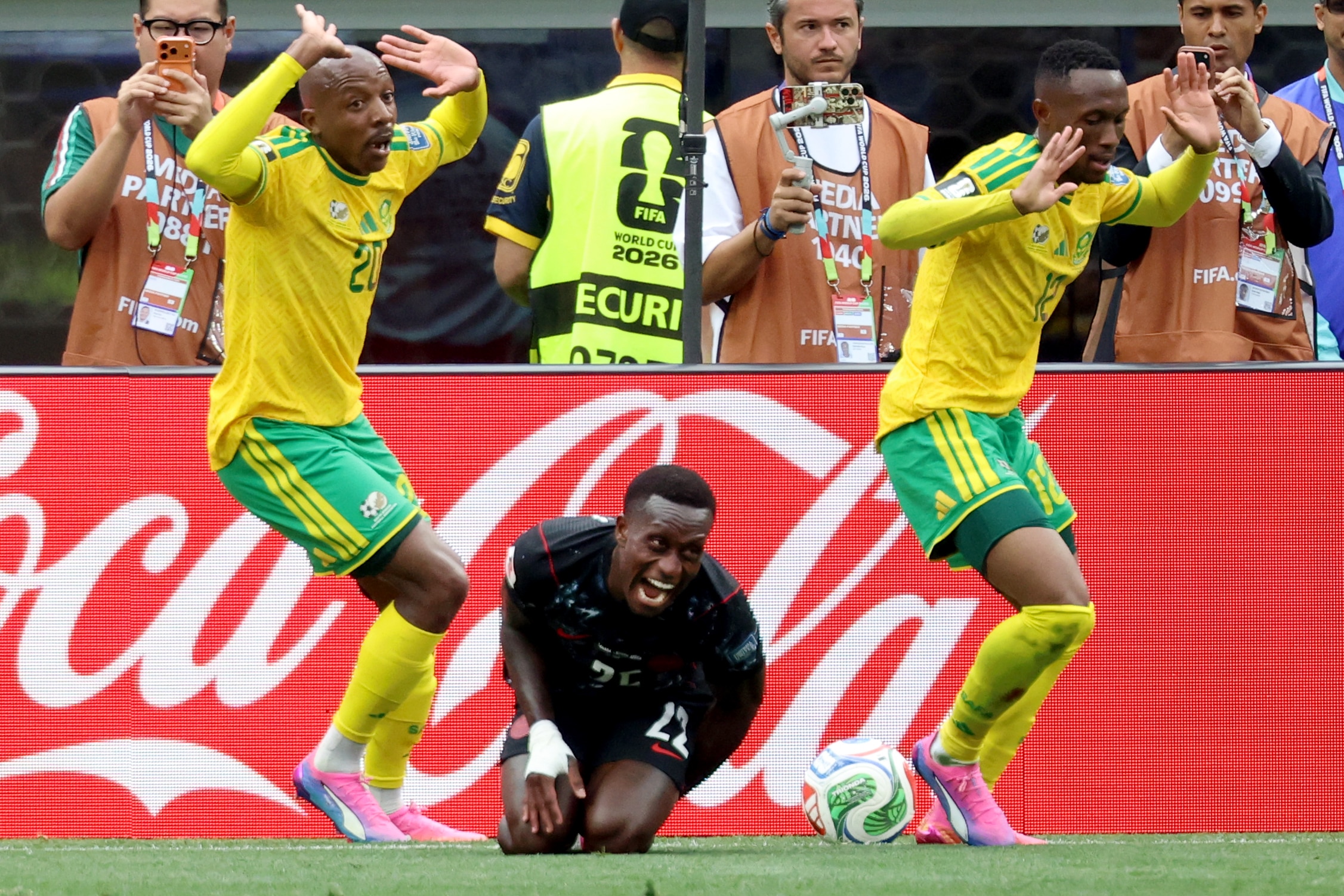 Khuliso Mudau and Thapelo Maseko hold up their hands as Richie Laryea yells